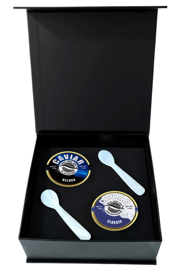 Caviar set with two 50g tins, mother-of-pearl spoons, and an ice pack. One tin labeled "Beluga" with large grayish-black grains, and one labeled "Classic" with smaller lighter-colored grains.